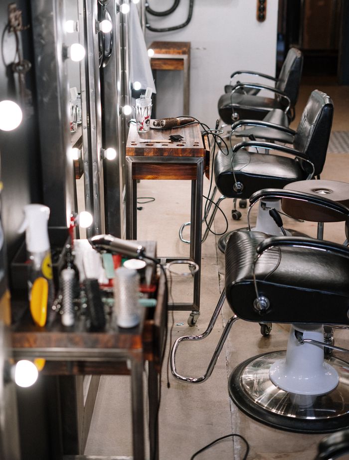 about-01 Bright and well-equipped hair salon with modern chairs and styling tools.